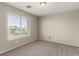 Bright bedroom features neutral walls and carpet, a large window with neighborhood views at 4705 Delicate Arch Ct, North Las Vegas, NV 89031