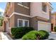 Well-kept two-story home with a two-car garage and mature shrubbery adding curb appeal at 4705 Delicate Arch Ct, North Las Vegas, NV 89031