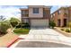 Inviting two-story home with a well-maintained lawn and a spacious two-car garage at 4705 Delicate Arch Ct, North Las Vegas, NV 89031