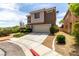 Two-story home features a well-manicured lawn and an attached two-car garage for convenience at 4705 Delicate Arch Ct, North Las Vegas, NV 89031