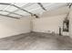 Attached garage featuring an automatic door opener, water heater, and room for parking and storage at 4705 Delicate Arch Ct, North Las Vegas, NV 89031
