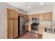 Bright kitchen features stainless steel appliances and oak cabinets offering ample storage at 4705 Delicate Arch Ct, North Las Vegas, NV 89031