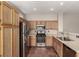Well-lit kitchen with stainless steel appliances, ample wood cabinetry, and light countertops at 4705 Delicate Arch Ct, North Las Vegas, NV 89031