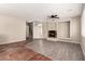 Spacious living room with fireplace, ceiling fan, wood, and tile flooring at 4705 Delicate Arch Ct, North Las Vegas, NV 89031