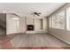Open living room features a decorative fireplace, ceiling fan, and ample natural light at 4705 Delicate Arch Ct, North Las Vegas, NV 89031