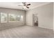 Carpeted primary bedroom with ceiling fan and bathroom access at 4705 Delicate Arch Ct, North Las Vegas, NV 89031