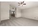 Carpeted main bedroom with ceiling fan and hallway access at 4705 Delicate Arch Ct, North Las Vegas, NV 89031