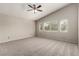 Spacious primary bedroom featuring carpet, ceiling fan, and windows at 4705 Delicate Arch Ct, North Las Vegas, NV 89031