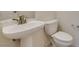 Bathroom featuring a pedestal sink, toilet, and modern fixtures at 494 Dart Brook Pl, Henderson, NV 89012