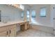 Bathroom featuring double sinks, a large mirror, and an elongated soaking tub at 494 Dart Brook Pl, Henderson, NV 89012