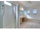 Bright bathroom featuring tile floors, glass shower door, and separate tub at 494 Dart Brook Pl, Henderson, NV 89012