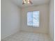 Bedroom with tile floors, ceiling fan, and large window offering great natural light at 494 Dart Brook Pl, Henderson, NV 89012