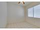Bedroom featuring tile floors, a ceiling fan, and a bright window at 494 Dart Brook Pl, Henderson, NV 89012