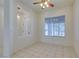 Bright dining room featuring an open floor plan with large windows, white walls, and ceramic tile flooring at 494 Dart Brook Pl, Henderson, NV 89012