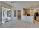 Bright kitchen featuring a breakfast bar, an open floor plan, white walls, and ceramic tile flooring at 494 Dart Brook Pl, Henderson, NV 89012
