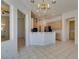 Bright kitchen featuring a breakfast bar, an open floor plan, white walls, and ceramic tile flooring at 494 Dart Brook Pl, Henderson, NV 89012