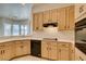 Open kitchen with ample counter space, tile flooring, and neutral wood cabinetry at 494 Dart Brook Pl, Henderson, NV 89012
