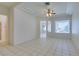 Bright living room featuring an open floor plan with large windows, white walls, and ceramic tile flooring at 494 Dart Brook Pl, Henderson, NV 89012