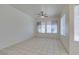 Spacious living room with tile flooring, ceiling fan, and large windows at 494 Dart Brook Pl, Henderson, NV 89012