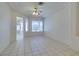 Bright living room featuring an open floor plan with large windows, white walls, and ceramic tile flooring at 494 Dart Brook Pl, Henderson, NV 89012