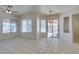 Open living room with tile flooring, large windows, and sliding glass door access to patio at 494 Dart Brook Pl, Henderson, NV 89012