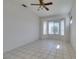 Spacious living room with tile flooring, ceiling fan, and a bright, airy feel at 494 Dart Brook Pl, Henderson, NV 89012