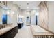 Stylish bathroom showcasing double vanities, a soaking tub with decorative tile accents and modern light fixtures at 5 Crystal Tree Pass, Henderson, NV 89052