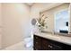 Stylish half bathroom with a sleek vanity, granite countertop, and modern fixtures offers convenience for guests at 5 Crystal Tree Pass, Henderson, NV 89052