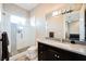 Contemporary bathroom with glass enclosed shower, dark wood vanity, and mosaic tile at 5 Crystal Tree Pass, Henderson, NV 89052