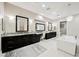 Elegant bathroom with dual vanities, soaking tub, and modern chandelier offers a spa-like experience at 5 Crystal Tree Pass, Henderson, NV 89052