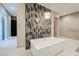 Bathroom with soaking tub and decorative tile is the perfect place to unwind after a long day at 5 Crystal Tree Pass, Henderson, NV 89052