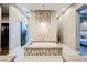 Elegant bathroom features a soaking tub with decorative tiled surround and a closet and vanity area beyond at 5 Crystal Tree Pass, Henderson, NV 89052