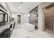 Stunning bathroom with dual vanities, a soaking tub, walk-in shower and mosaic tile accents offers a luxurious spa experience at 5 Crystal Tree Pass, Henderson, NV 89052