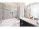 Modern bathroom featuring sleek gray tile, a glass-enclosed shower, and a stylish vanity with countertop at 5 Crystal Tree Pass, Henderson, NV 89052