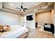 Relaxing bedroom suite with a tray ceiling, ceiling fan, and private outdoor access at 5 Crystal Tree Pass, Henderson, NV 89052