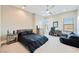 Spacious bedroom with large windows, dark furniture, and a comfortable beanbag chair at 5 Crystal Tree Pass, Henderson, NV 89052