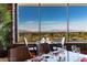 Elegant dining area boasts floor to ceiling window view of the golf course and mountain landscape at 5 Crystal Tree Pass, Henderson, NV 89052