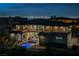Night shot of a modern two-story home featuring a pool, jacuzzi, and views of the Las Vegas Strip at 5 Crystal Tree Pass, Henderson, NV 89052