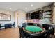 Spacious game room with a poker table, modern bar, and wood flooring provides a perfect entertainment space at 5 Crystal Tree Pass, Henderson, NV 89052