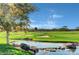 Scenic view of the lush golf course with tranquil stream, mature trees, and undulating green landscape at 5 Crystal Tree Pass, Henderson, NV 89052