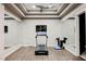 Home gym featuring treadmill, wall mirrors, and wood flooring at 5 Crystal Tree Pass, Henderson, NV 89052