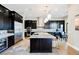 Elegant kitchen with dark wood cabinetry, a central island with seating, and stainless steel appliances at 5 Crystal Tree Pass, Henderson, NV 89052