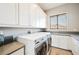 Bright laundry room with plenty of storage space and modern washer and dryer at 5 Crystal Tree Pass, Henderson, NV 89052