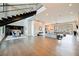 Bright, open-plan living room features hardwood floors, modern staircase, and seamless flow to the dining and outdoor spaces at 5 Crystal Tree Pass, Henderson, NV 89052