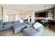 Spacious living room featuring a large sectional couch and views into the entertainment area and bar at 5 Crystal Tree Pass, Henderson, NV 89052