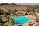 Aerial shot of a resort style pool with palm trees, covered seating areas, and plenty of lounge chairs at 5 Crystal Tree Pass, Henderson, NV 89052