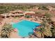 Community pool, showcasing ample lounge seating, palm trees, and covered seating areas at 5 Crystal Tree Pass, Henderson, NV 89052