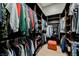 Spacious walk-in closet with ample storage and wood shelving and racks for clothing and accessories at 5 Crystal Tree Pass, Henderson, NV 89052