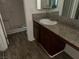 Bathroom featuring wood-look flooring, granite countertops, and shower-tub combo at 5170 S Jones Blvd # 108, Las Vegas, NV 89118