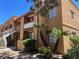 Multi-story condo building featuring balconies, desert landscaping, and stucco exterior at 5170 S Jones Blvd # 108, Las Vegas, NV 89118